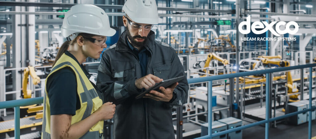 team members in warehouse looking at tablet