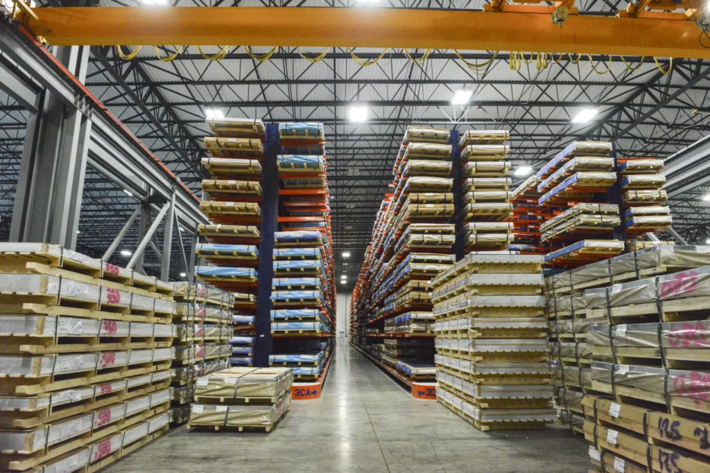 Dexco cantilever racks storing heavy steel plate organized by size at a metals distribution facility