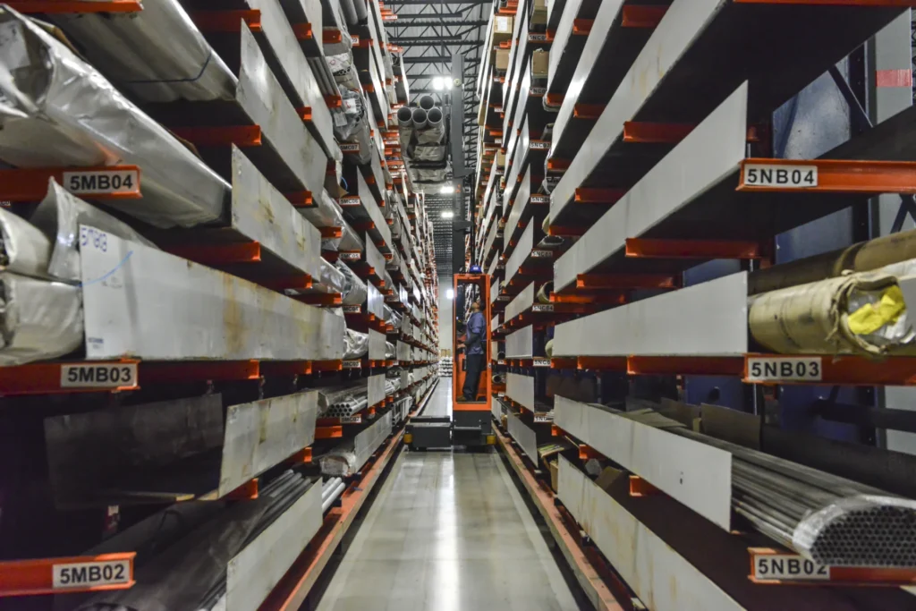 Dexco cantilever racks storing various sizes of steel bar and tube at a metals distribution facility